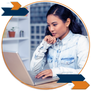 A woman working at a laptop.